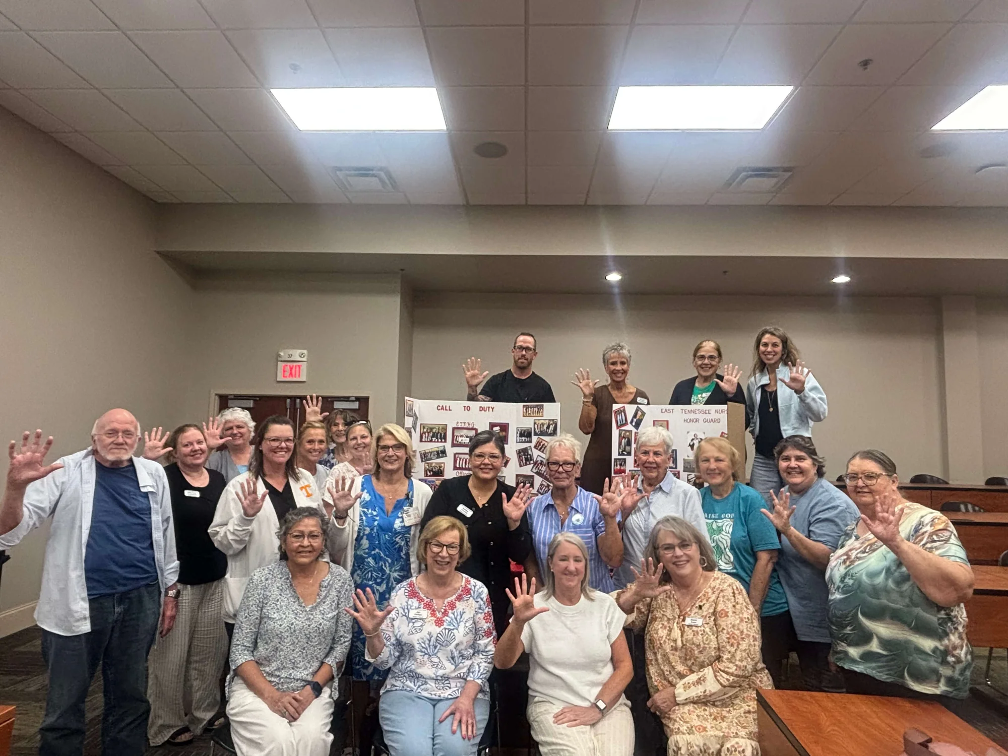 Members of the guard gathered in front of the chapter’s display boards, each holding up five fingers for the chapter’s fifth birthday.