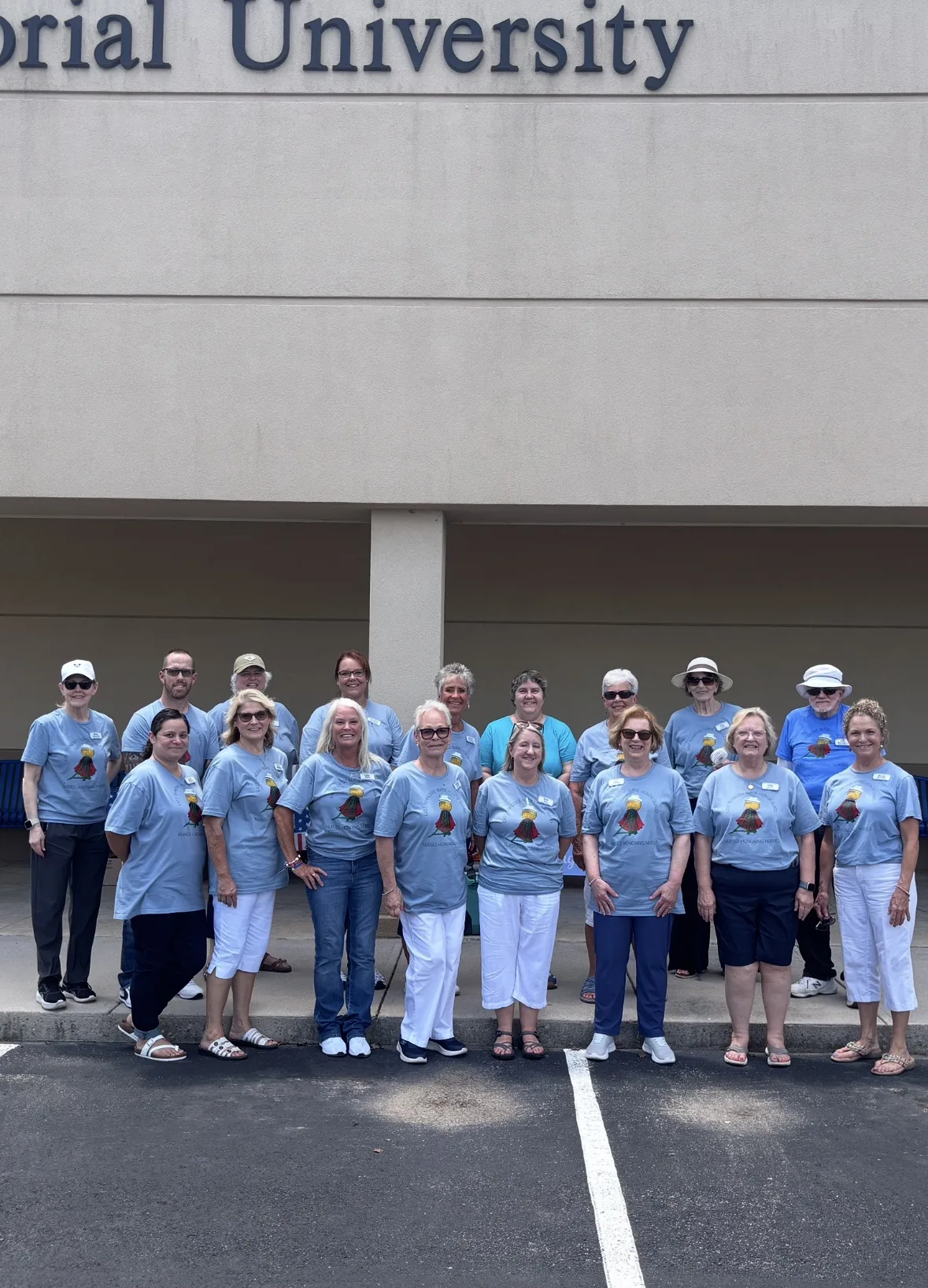 Chapter volunteers in light blue t-shirts gathered beneath the Lincoln Memorial University sign on Butts for a Cause collection day, 2026.