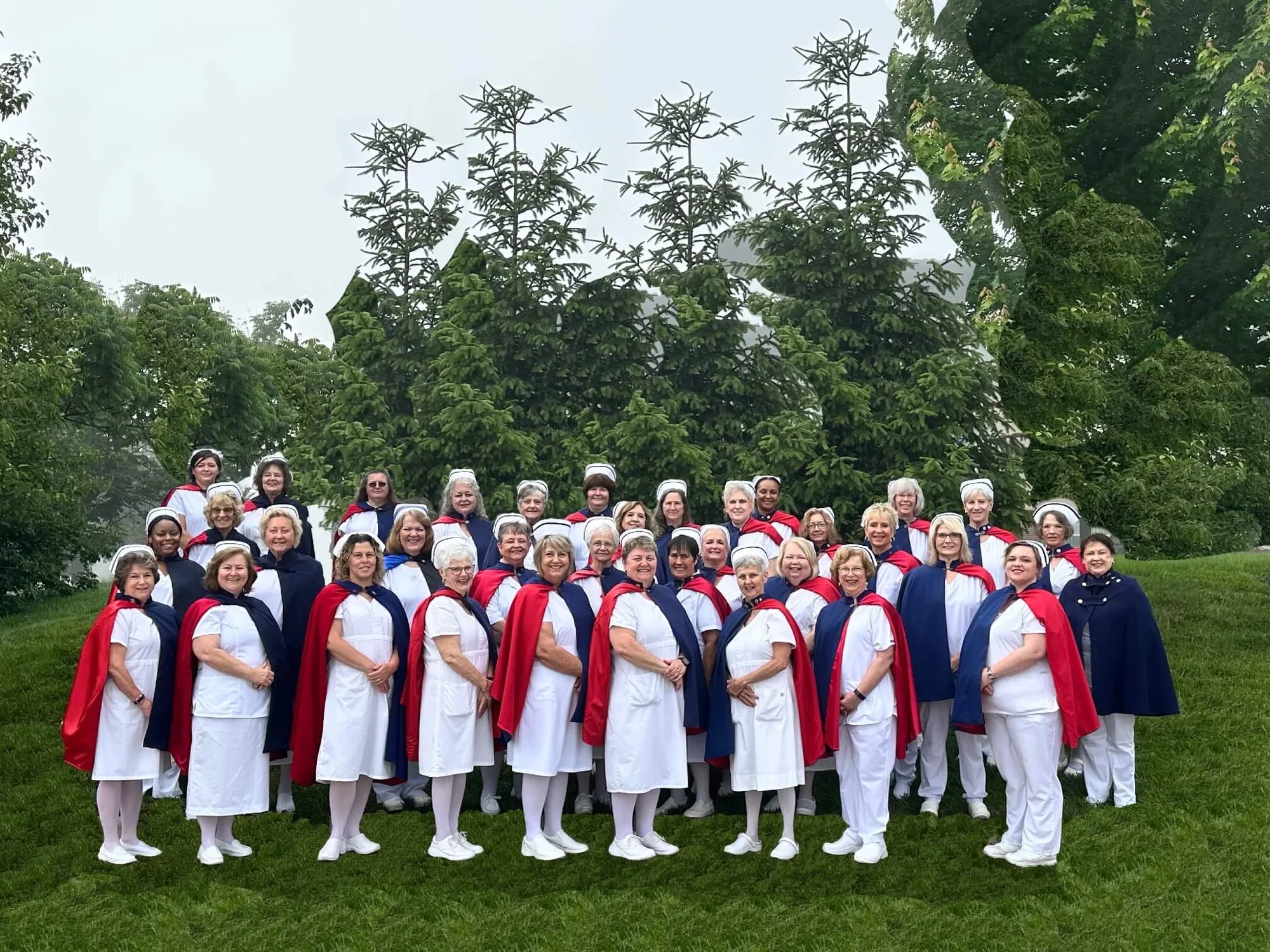 A large group of nurse honor guard members from many chapters standing in rows on a lawn at the 2024 national convention.