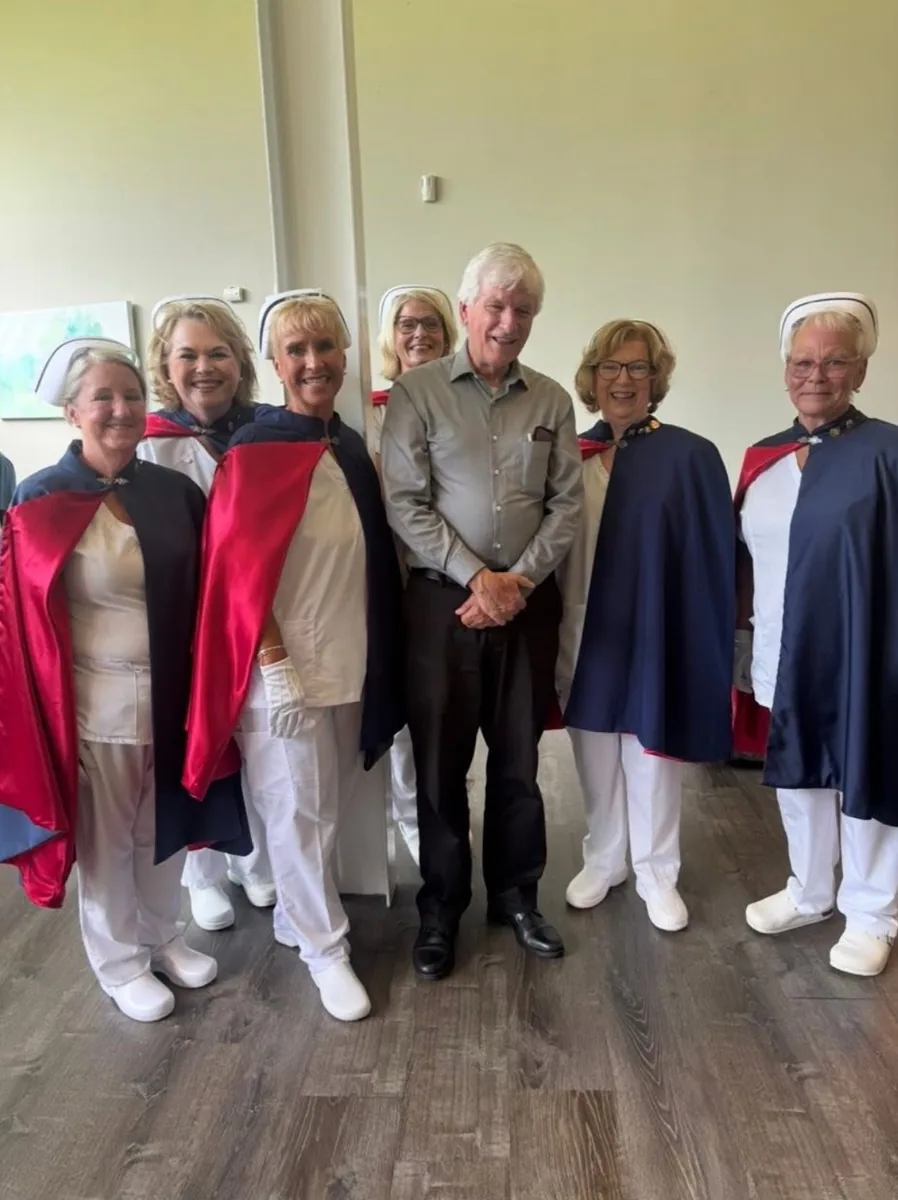 Five honor guard members in uniform standing with the chapter chaplain.
