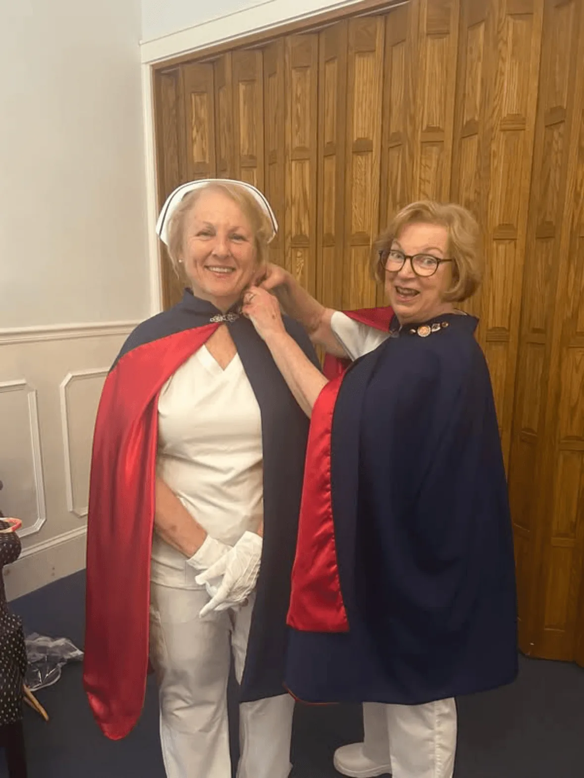 AJ Olson, in white uniform and cape, being pinned by Jan Phillips to mark a first service with the East Tennessee Nurse Honor Guard.