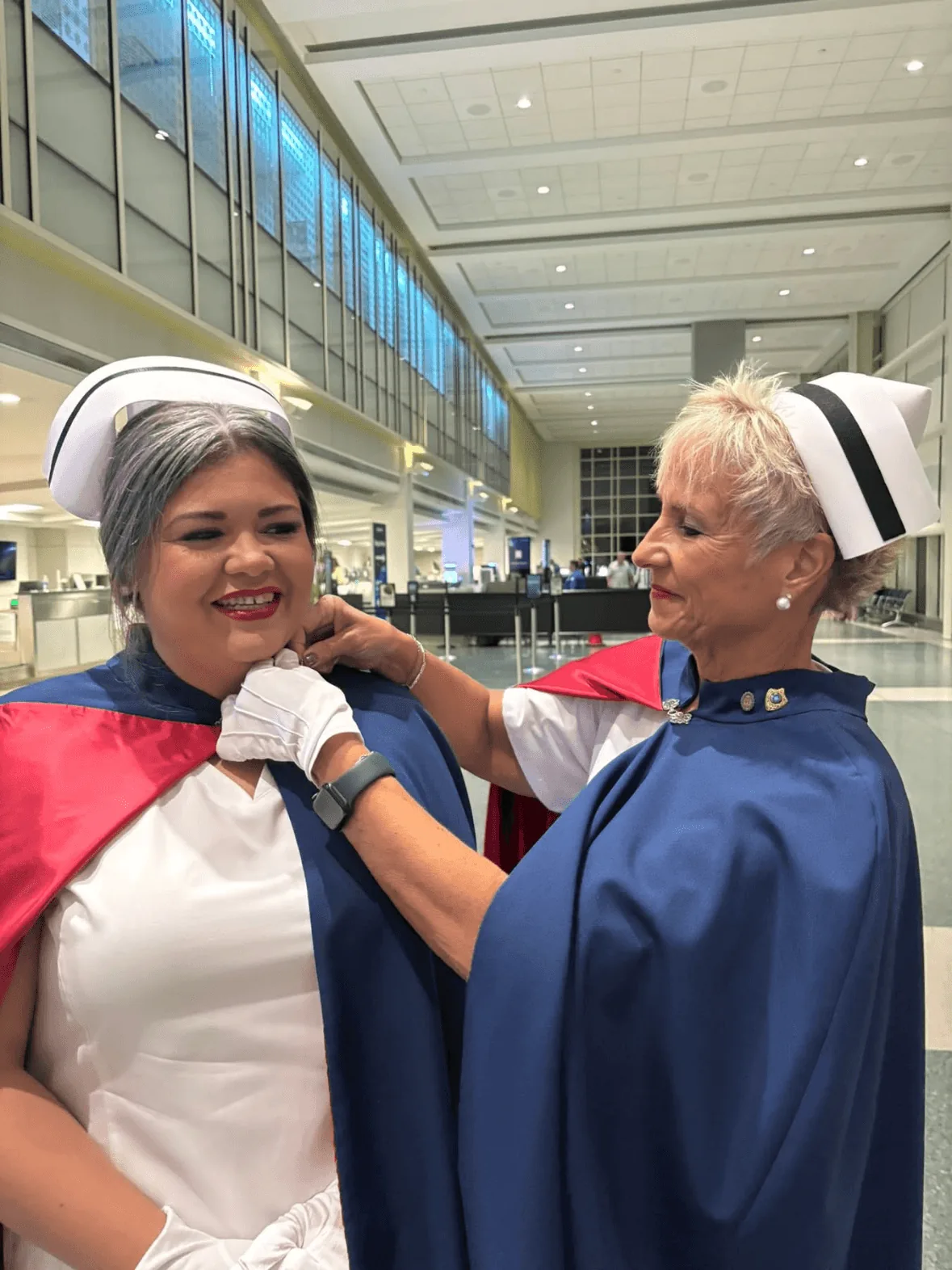 Ashley Crowley, in white uniform and cape, being pinned by Melanie Pfennigwerth to mark a first service with the East Tennessee Nurse Honor Guard.