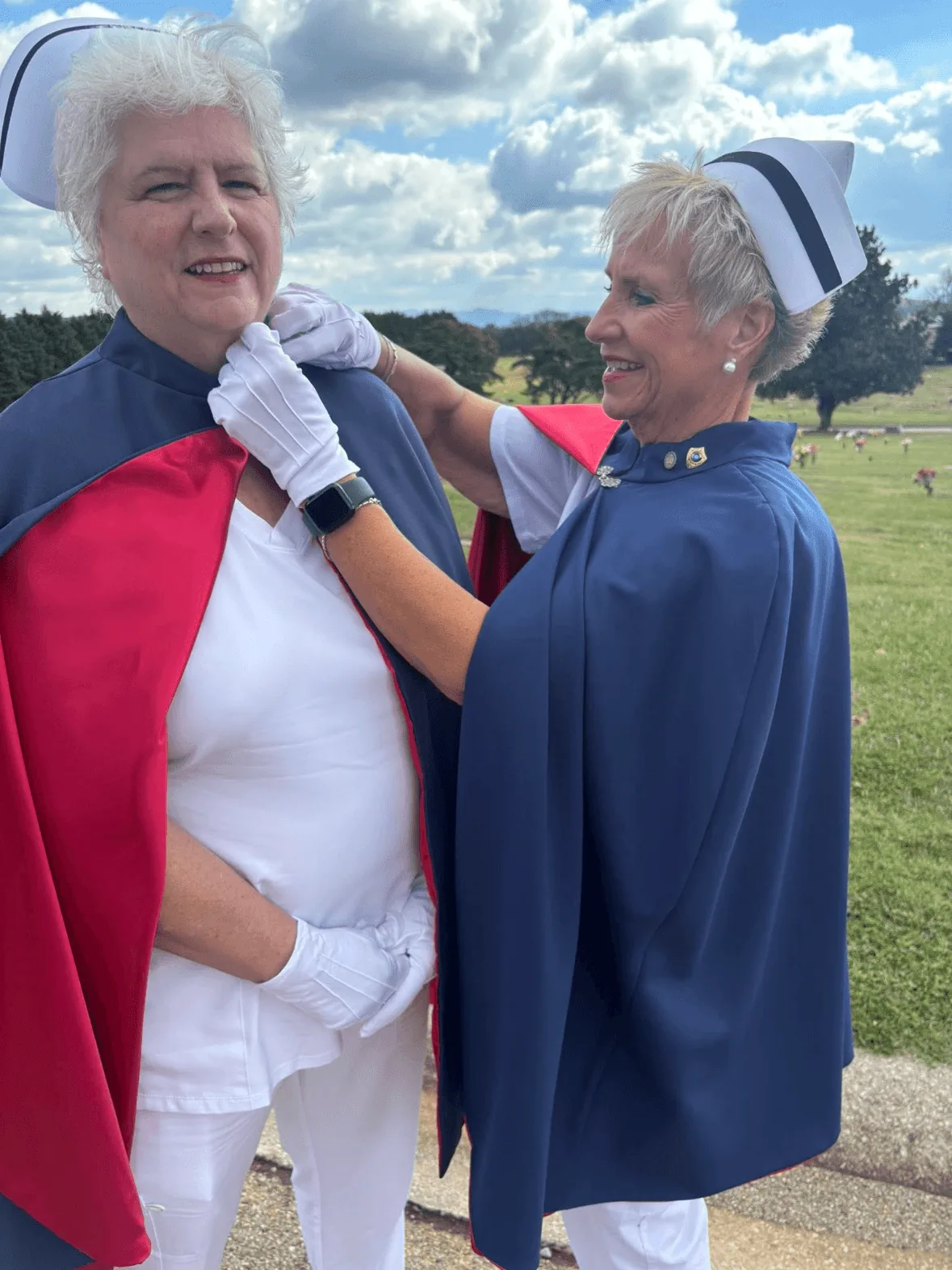 Hope Bruce, in white uniform and cape, being pinned by Melanie Pfennigwerth to mark a first service with the East Tennessee Nurse Honor Guard.