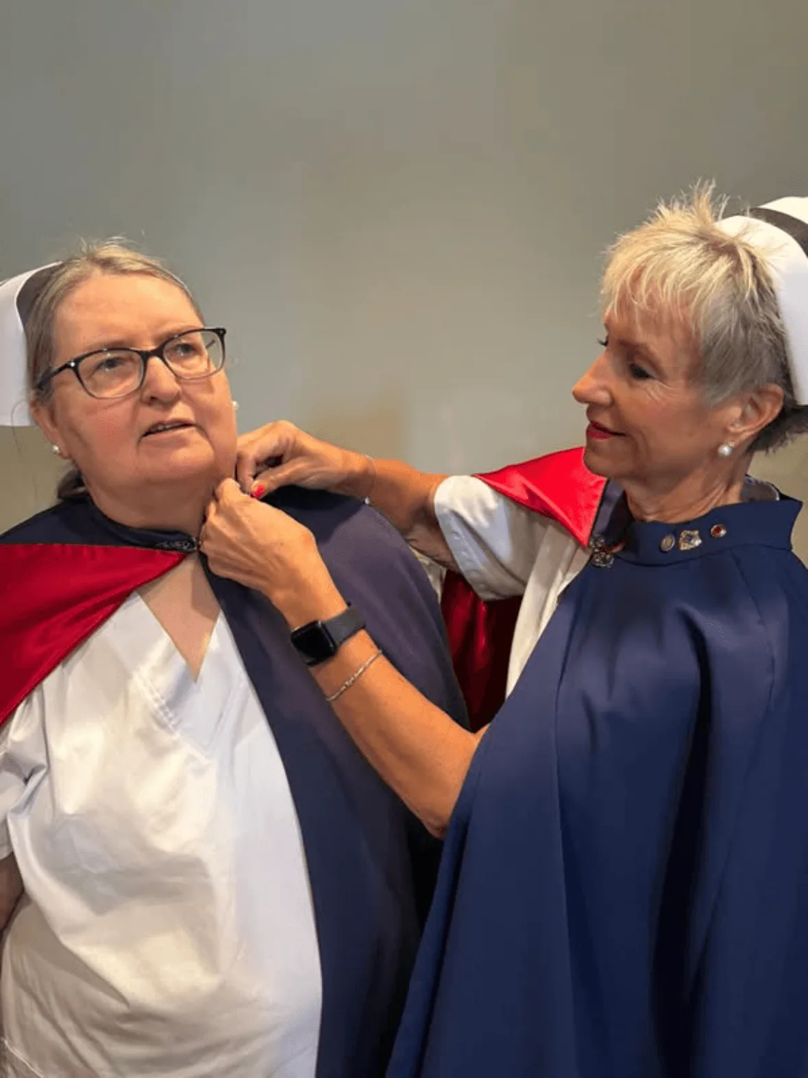 Mary Cantrell, in white uniform and cape, being pinned by Melanie Pfennigwerth to mark a first service with the East Tennessee Nurse Honor Guard.