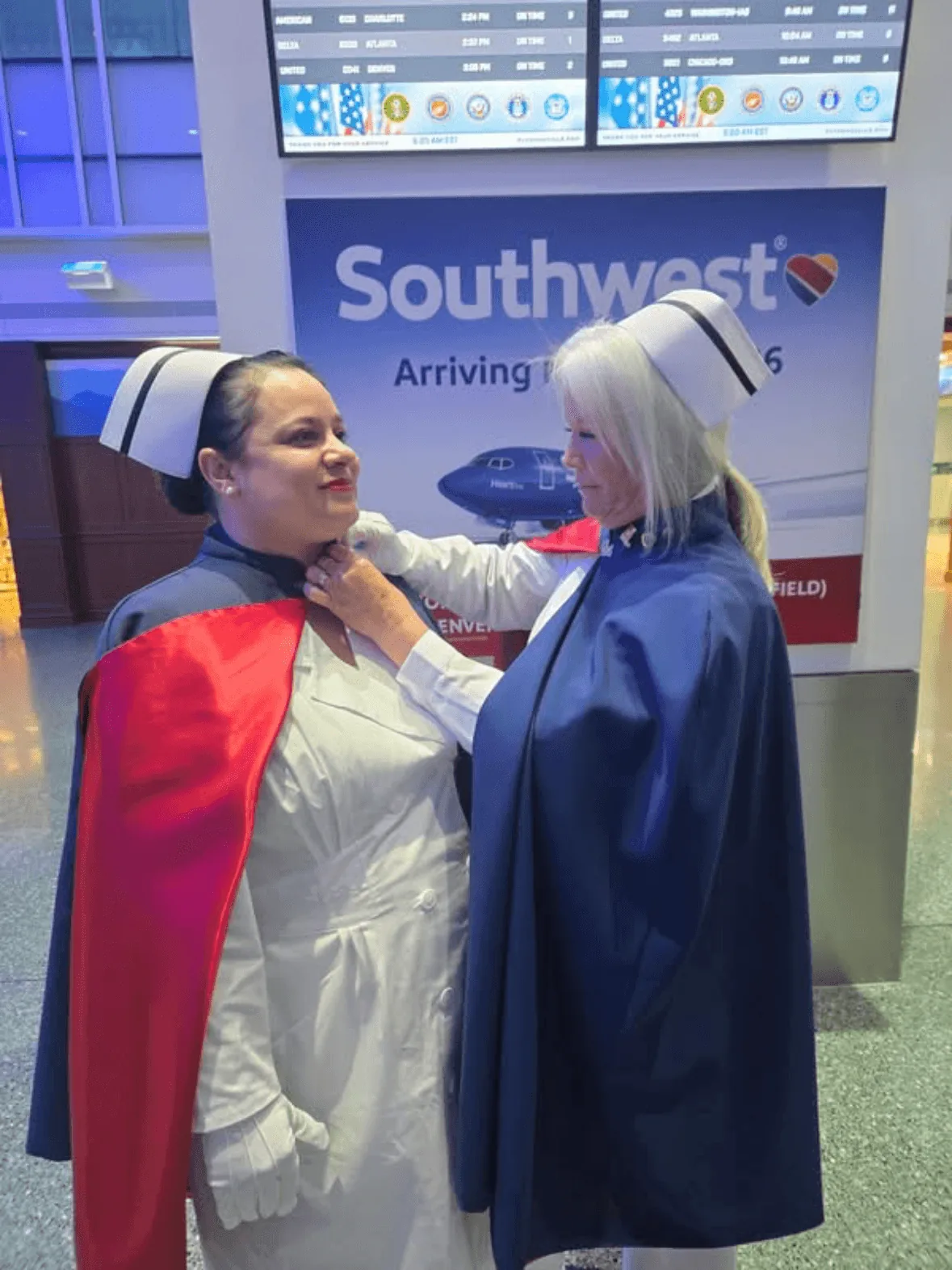 Nadah Williams, in white uniform and cape, being pinned by Cathy Felker to mark a first service with the East Tennessee Nurse Honor Guard.